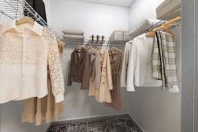 A row of clothes hanging on a rack.