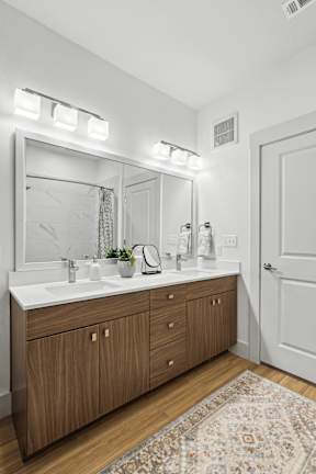 a bathroom with a large mirror and a sink