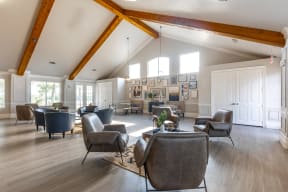 a large living room with couches chairs and a table