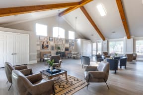 a large living room with couches chairs and a table