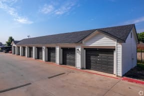a garage with a row of doors on the side of a street