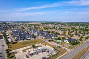an aerial view of a neighborhood with houses and a parking lot