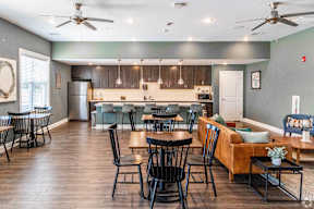 A kitchen with a dining table and chairs.