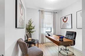 a home office with a desk and a window