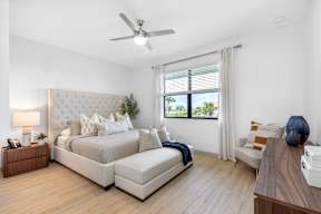 a bedroom with a bed and a ceiling fan