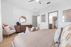 a bedroom with a large bed and a mirror