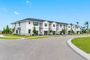 a large white house with a street in front of it