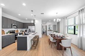 a large kitchen and dining area with a table and chairs