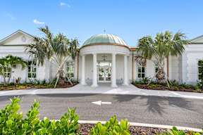 a white building with a domed roof and palm trees