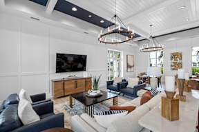 a living room with couches and chairs and a tv