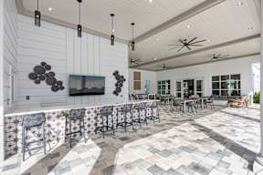 a large lobby with a bar and tables with chairs
