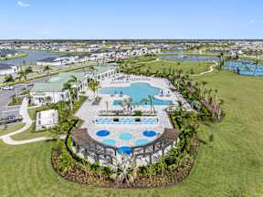 an aerial view of a resort with a swimming pool