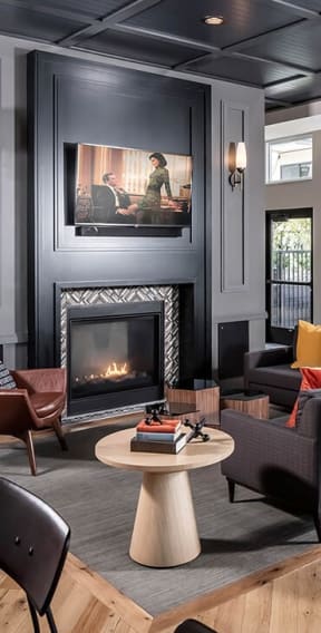 a living room with a fireplace and a painting on the wall at the Vintage on Selby in St. Paul, MN
