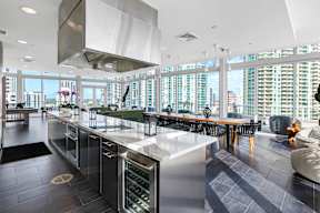Sky-Lounge kitchen with a long counter and a view of the city.