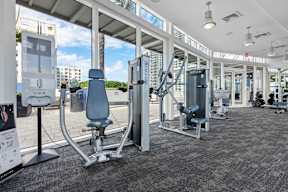 A gym with a variety of equipment including a leg press machine.