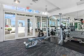 A gym with a view of the city outside the windows.