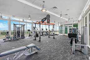 A gym with a variety of equipment including a leg press machine.