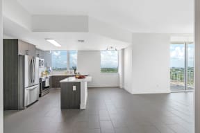 an open kitchen with stainless steel appliances and a island in the middle