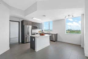 an open kitchen with stainless steel appliances and a large window