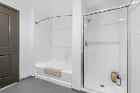 a white bathroom with a shower and a tub