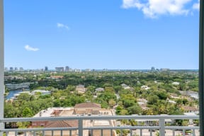 the view of the city from the balcony of a condo