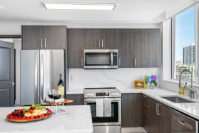 a kitchen with stainless steel appliances and a marble counter top