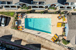 A large swimming pool surrounded by yellow sun loungers.