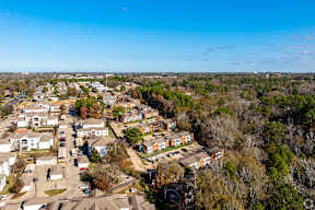 A bird's eye view of a residential area with houses and trees.