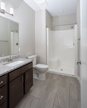 a bathroom with a toilet sink and shower  at RoCo Apartments, Fargo