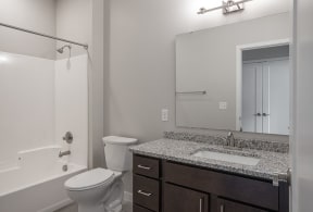 a bathroom with a toilet sink and shower  at RoCo Apartments, Fargo, ND