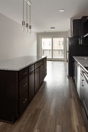 a kitchen with a counter top and a refrigerator  at RoCo Apartments, Fargo, 58102