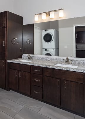 a bathroom with a sink and a washer and dryer  at RoCo Apartments, Fargo, ND