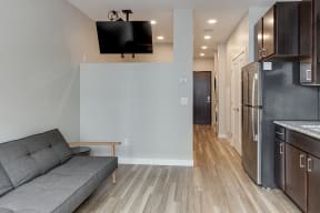 a living room with a couch and a tv  at RoCo Apartments, Fargo, North Dakota