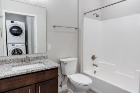 a bathroom with a washer and dryer in it  at RoCo Apartments, North Dakota