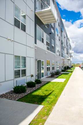 A long building with a lot of windows and a green strip down the side.