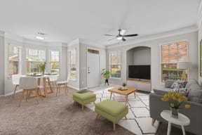 a living room with a couch and a table with chairs