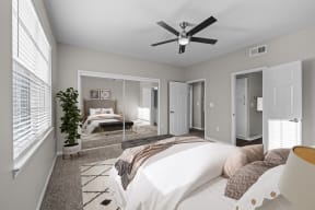 a bedroom with a large bed and a ceiling fan