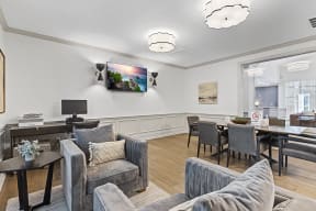 a living room with couches and chairs and a table and a tv