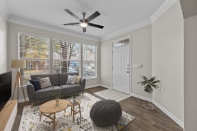 a living room with a couch and a ceiling fan