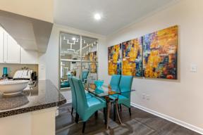 A dining room with a table and chairs.
