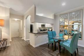 A modern kitchen with a dining table and chairs.