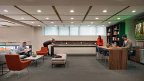 a rendering of the lobby of a library with people working at a desk and chairs