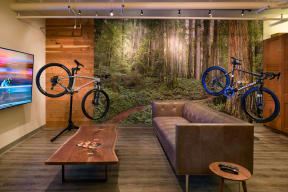 a living room with two bikes on the wall and a couch