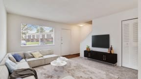 a living room with a couch and a television at Courthouse Green Apartments, Chesterfield , VA
