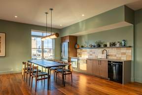 A modern kitchen with a dining table and chairs.