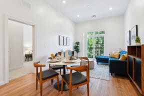 an open living room with a dining room table and chairs