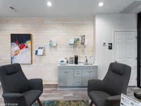 a room with two chairs and a desk in front of a wall with a painting on it at Courthouse Green Apartments, Chesterfield , Virginia