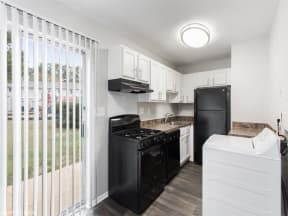 a kitchen with a black stove top oven next to a refrigerator at Courthouse Green Apartments, Chesterfield ,Virginia, 23832