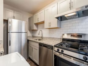 a kitchen with white cabinets and stainless steel appliances at Courthouse Green Apartments, Chesterfield , VA