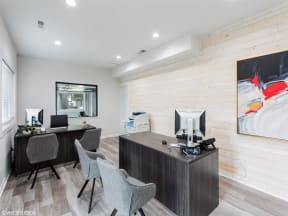 two computers and two chairs in an office with a wood wall at Courthouse Green Apartments, Chesterfield 